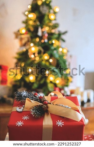 beautiful gift on a bokeh background with a Christmas tree. Copy space