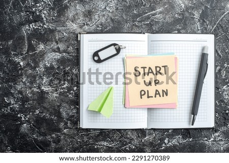 top view start up plan note on sticker inside open copybook on gray background lesson student notepad note school study paper sticker
