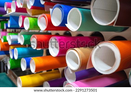 Vinyl self-adhesive film on the shelves of the store.Sale of multi-colored film for design and visual design. External tuning. Royalty-Free Stock Photo #2291273501