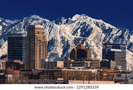 A record-breaking snowpack in the Wasatch Mountains behind the downtown Salt Lake City skyline, Utah. Royalty-Free Stock Photo #2291280339