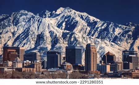 A record-breaking snowpack in the Wasatch Mountains behind the downtown Salt Lake City skyline, Utah. Royalty-Free Stock Photo #2291280351