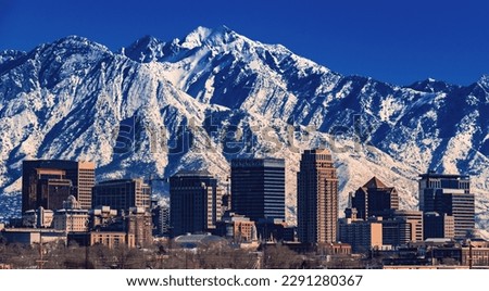 A record-breaking snowpack in the Wasatch Mountains behind the downtown Salt Lake City skyline, Utah. Royalty-Free Stock Photo #2291280367