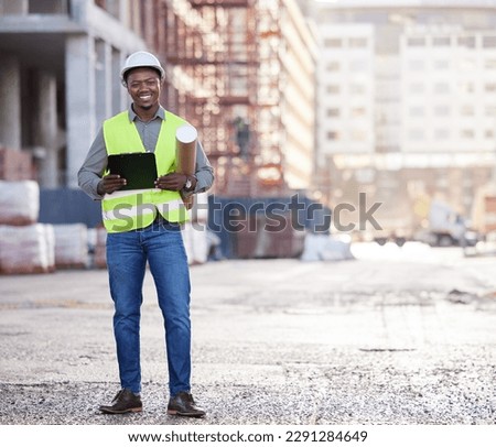 Its all going according to plan. Full length portrait of a handsome young construction worker standing with blueprints and clipboard on a building site.