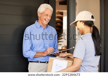 Just sign right there. a handsome senior man taking delivery of a package from a female courier.