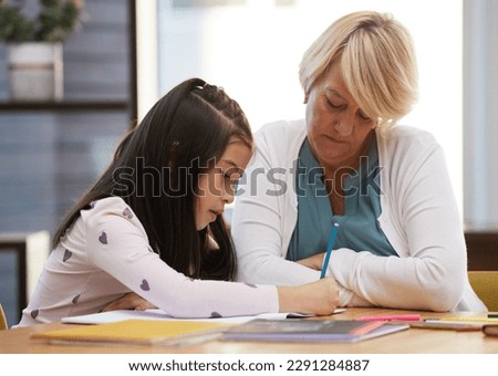 Its a picture of you and me grandma. a woman sitting with her granddaughter while doing artwork.