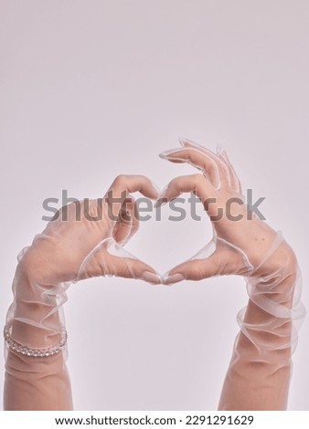 Female hands in transparent black gloves on dress background. Retro style