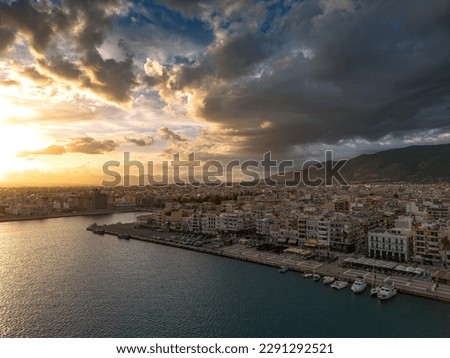 Aerial iconic sunset view over the port of Kalamata seaside city in Messenia, Greece.