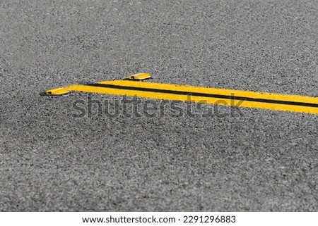 Double yellow lines on asphalt road with reflectors