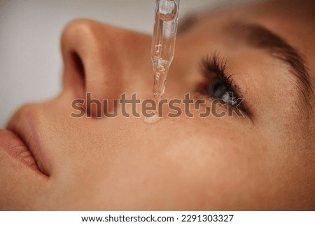 Facial skincare using gadgets and serums for smoother, moisturized skin and reduced wrinkles. High quality photo Royalty-Free Stock Photo #2291303327