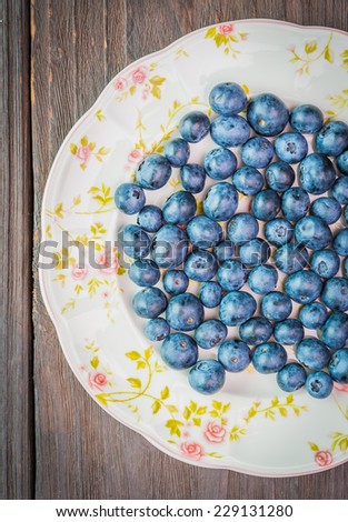 Blueberry dish on wooden background - dark effect pictures style