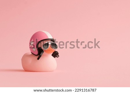 Creative composition made of pink cute little rubber duckling with a helmet and sunglasses on pink background.Summer minimal duck concept. Creative art, Contemporary style.Writing space, copy space. Royalty-Free Stock Photo #2291316787