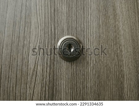 A keyhole of a desk drawer with a wedge pattern surface Royalty-Free Stock Photo #2291334635