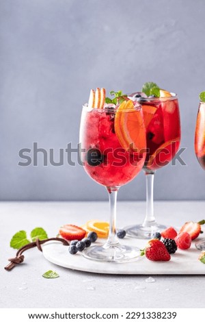 Refreshing summer berry sangria with red wine, apples and oranges Royalty-Free Stock Photo #2291338239