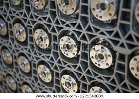 Lots of crankshafts for car engines. The shafts are installed in special boxes, only the connecting flanges are visible Royalty-Free Stock Photo #2291343039