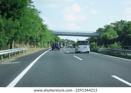 A car running smoothly on a highway Royalty-Free Stock Photo #2291344213