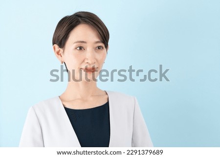 Asian businesswoman on blue background
