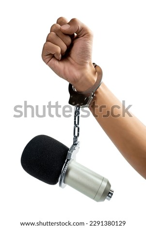 A human hand in a handcuff with a microphone isolated over white background