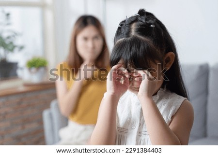 Asian angry mother scold her stubborn daughter while her daughter crying. Royalty-Free Stock Photo #2291384403