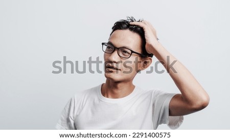 Young confident asian chinese young man checking hair style and dandruff.