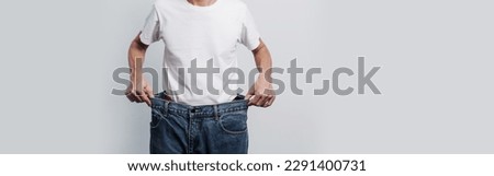 Young confident asian chinese weight loss man with oversize of jean pants. Royalty-Free Stock Photo #2291400731