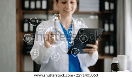 Medicine doctor using digital tablet and smartphone diagnose virtual electronic medical record on interface.Digital healthcare and network on virtual screen medical technology. in office