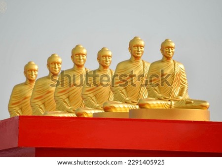 Golden Buddha meditating on a red pedestal