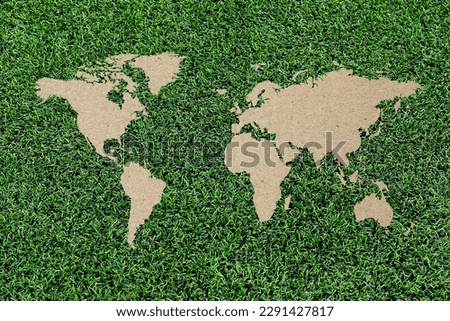 Green grass world map on cardboard paper background.
World Environment Day June 5.