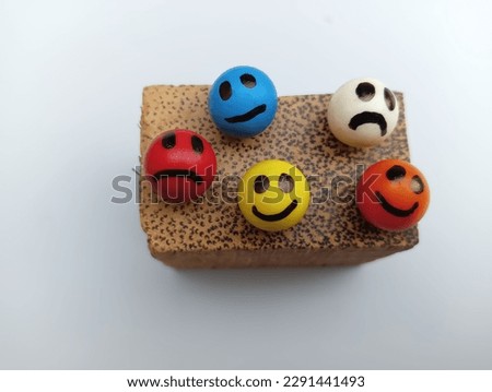 Kerala, 20  April 2023: colourful smiles arranged on wooden piece 