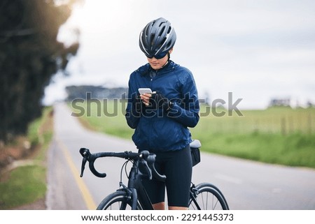 Woman, bicycle athlete and outdoor with phone for social media technology, mobile app or search gps direction. Female cyclist, bike and typing on smartphone for network notification, sport or cycling