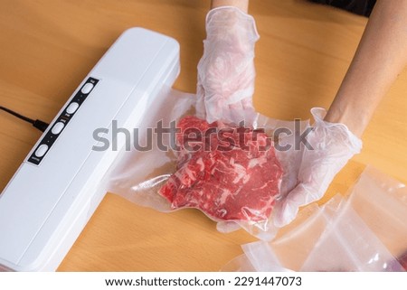 Raw beef meat sealed in plastic shrink wrap with vacuum sealer Royalty-Free Stock Photo #2291447073