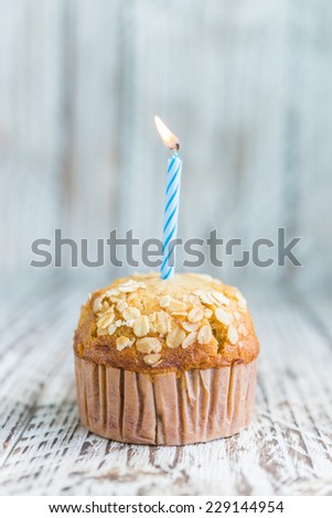 Birthday Banana muffin on wooden background