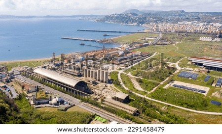 Aerial view of the ex Italsider area of Bagnoli from the Posillipo hill, in the metropolitan city of Naples, Campania, Italy. It's a disused industrial complex on the coast of Mediterranean sea. Royalty-Free Stock Photo #2291458479
