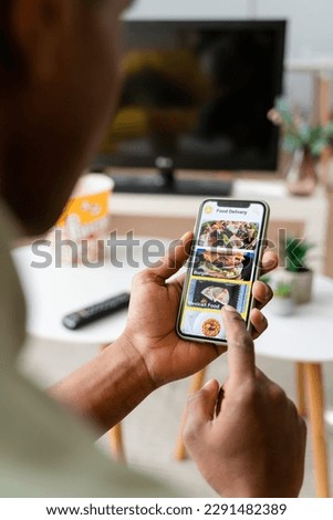 Crop black woman using smartphone