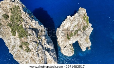 Amazing aerial view of Faraglioni in summer season. Rock natural formations in Capri Island, Italy.