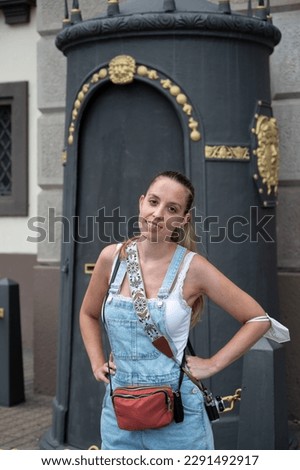 Portrait of a young girl dressed in a Texan dungarees in summer, wears orthodontics, braces Royalty-Free Stock Photo #2291492917