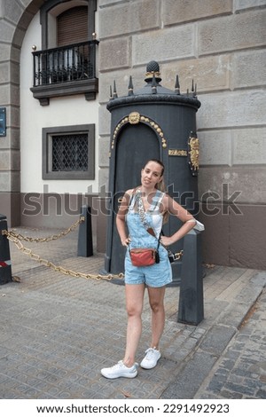Portrait of a young girl dressed in a Texan dungarees in summer, wears orthodontics, braces Royalty-Free Stock Photo #2291492923
