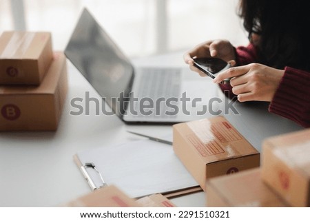 People taking photos of parcel boxes, selling products online, packing products according to orders from customers who ordered through online shopping sites. Selling products online and e-commerce.