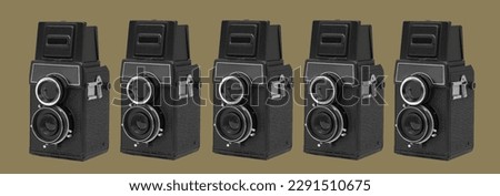 some black retro medium format film cameras on an olive green background in a panoramic format to use as web banner or header