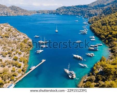 Aerial drone photo of Binlik Bay, located in the midst of Göcek and Dalaman, Fethiye. Daily tour boats and private yachts anchor to have serenity and enjoy the secluded bay. Royalty-Free Stock Photo #2291512391