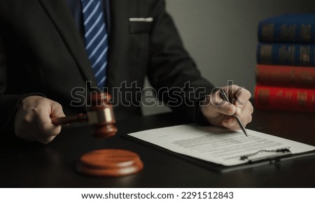 Male lawyer working in a law firm Judge wrestling with scales of justice. Law, lawyer, advice and justice.