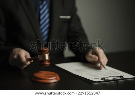 Male lawyer working in a law firm Judge wrestling with scales of justice. Law, lawyer, advice and justice. Royalty-Free Stock Photo #2291512847
