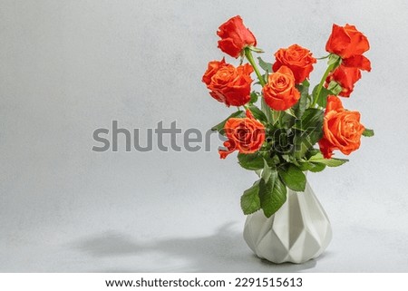 Bouquet of fresh bright roses on vase. Romantic gift concept, greeting card. Valentines, Woman's or Mothers Day. Wedding, Anniversary, Birthday, flat lay, stone concrete background, copy space