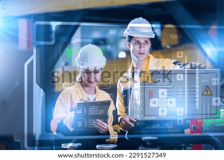 Professional engineering. Industry 4.0 Modern Factory Project Engineer Operator who Controls Facility Production Line, Uses Computer with Screens Showing AI, Machine Learning Enhanced Assembly Process