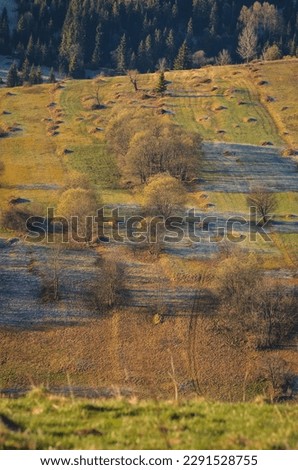Nice morning spring landscape in the countryside. View of the hills in the village of Osturna in Slovakia illuminated by the morning sun.