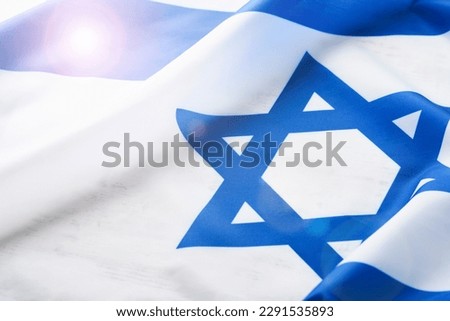 Independence Day of Israel. National Israel flag with star of David over white wooden background. Close up. National flag with place for text.