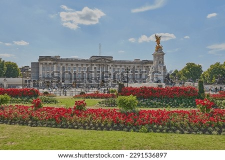 Panoramic picture of Buckingham Palace with crowed of visitors in summer with beautiful garden