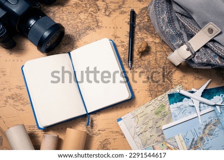Travel planning and photography: Camera, maps and notepad