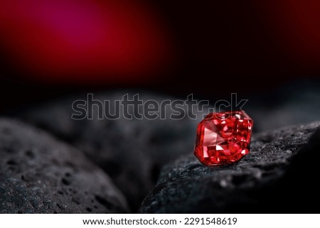Red Sapphire Gemstone on Black Natural Stone Royalty-Free Stock Photo #2291548619