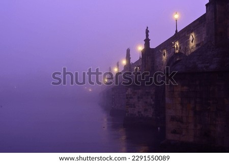 Charles Bridge on Vltava River in Prague Old Town. Early morning. Heavy fog. Royalty-Free Stock Photo #2291550089