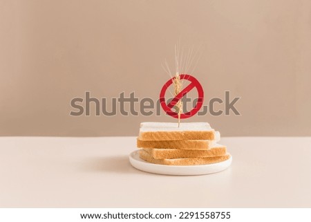 Gluten free bread on beige background with symbol crossed sprinkle. Gluten free concept. Royalty-Free Stock Photo #2291558755